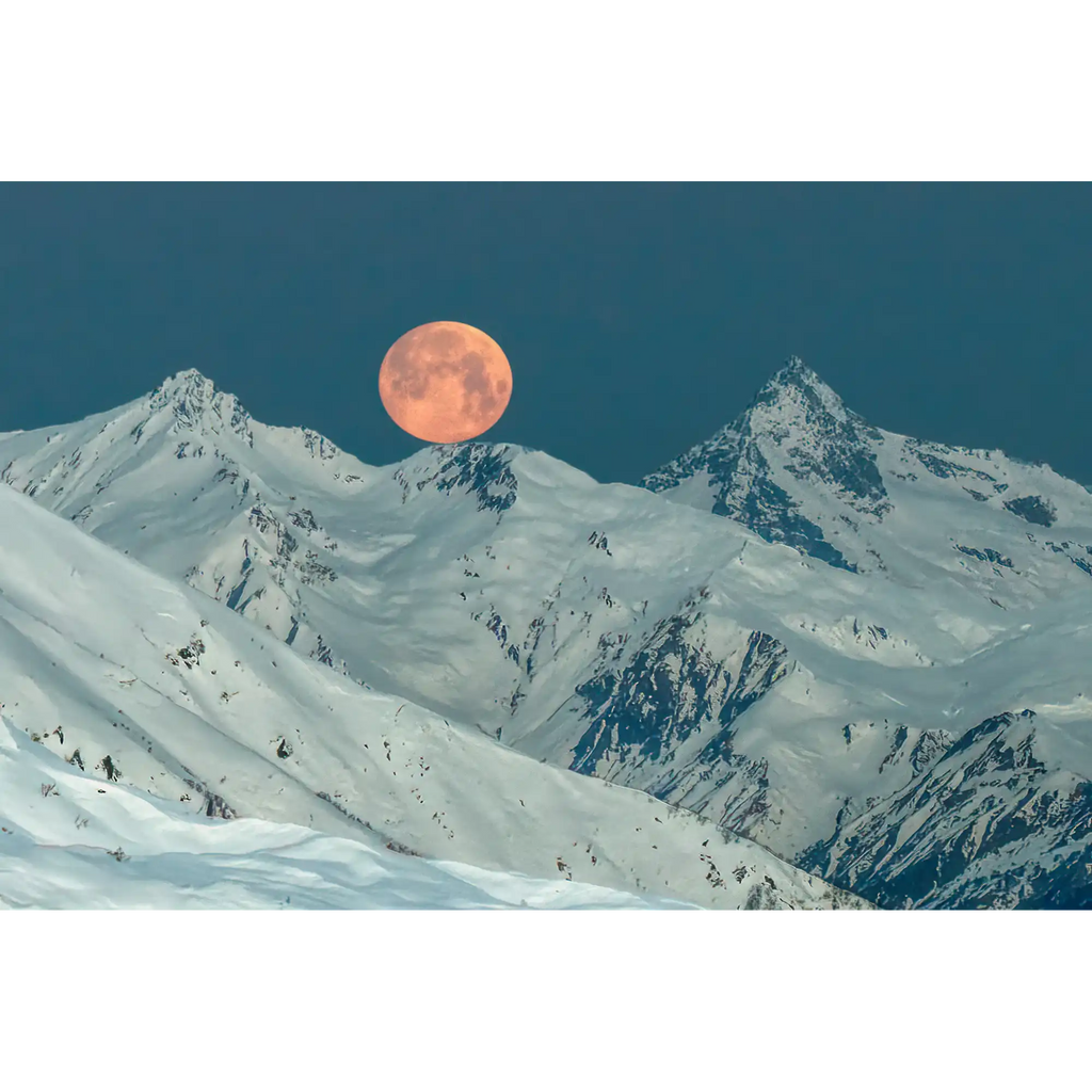 Full moon setting over peaks of the Greater Caucasus Range by Martin Hawes
